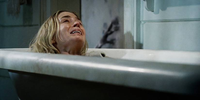 A terrified Evelyn (Emily Blunt) lies in a bathtub, about to give birth in 'A Quiet Place'