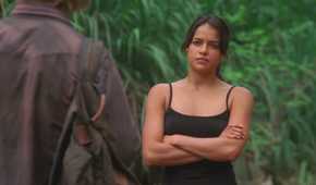 Ana Lucia (played by Michelle Rodriguez), confronts Sawyer (Josh Holloway) in the jungle with her arms crossed in Lost’s Season 2 Episode ‘Two for the Road.’