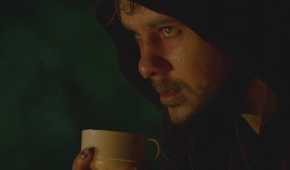 A sweat-soaked Charlie (Dominic Monaghan), battles heroin withdrawals while drinking tea in Lost.