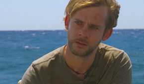 Charlie (Dominic Monaghan), begins to cry on the beach