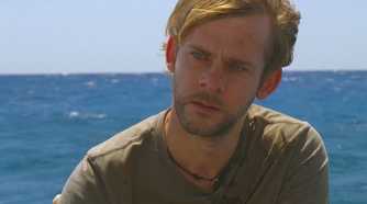 Charlie (Dominic Monaghan), begins to cry on the beach