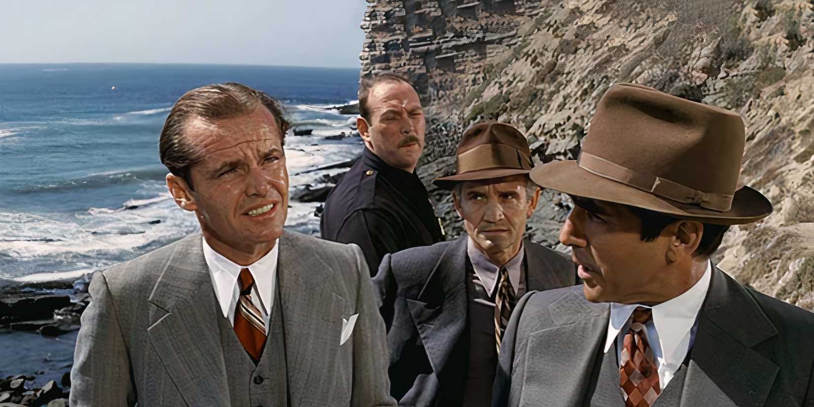 A small group of men in business suits talk to each other near a cliff and an ocean in Chinatown, 1974.