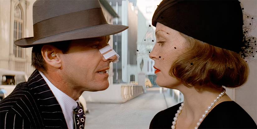 Jack Nicholson with a bandage on his nose leaning close to Faye Dunaway's face in Chinatown.