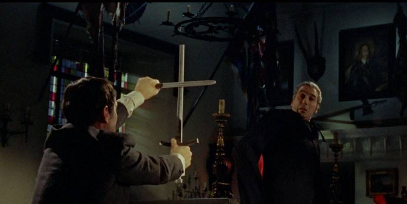 A man showing a cross to Dracula in Dracula Prince of Darkness