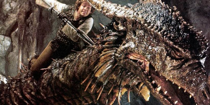 Galen (Peter MacNicol) straddles the terrible dragons Vermithrax, stabbing at him with a spear in 'Dragonslayer' (1981).