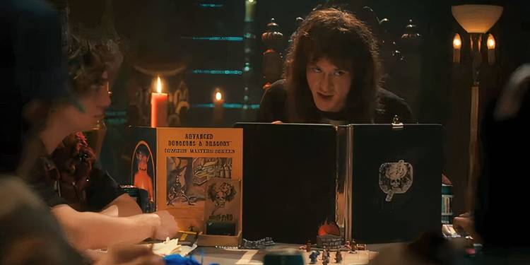 Eddie acts as Dungeon Master behind his D&D book around a table of the main cast in Stranger Things