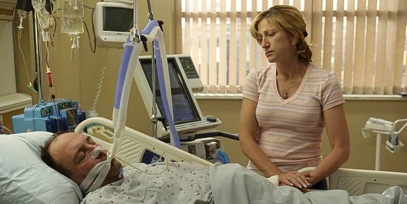Edie Falco stands by James Gandolfini laying in a hospital bed unconscious from the episode Join the Club in The Sopranos