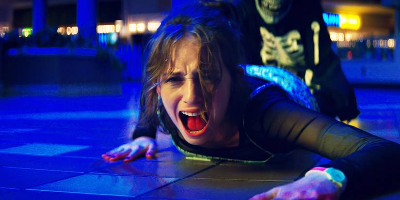 Heather, played by actor Maya Hawke, screaming while being dragged by someone in Fear Street Part One 1994