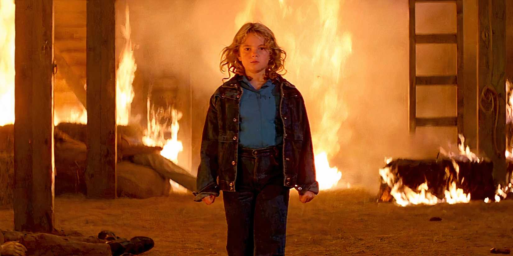Charlie standing in a flaming house in 'Firestarter' (1984)
