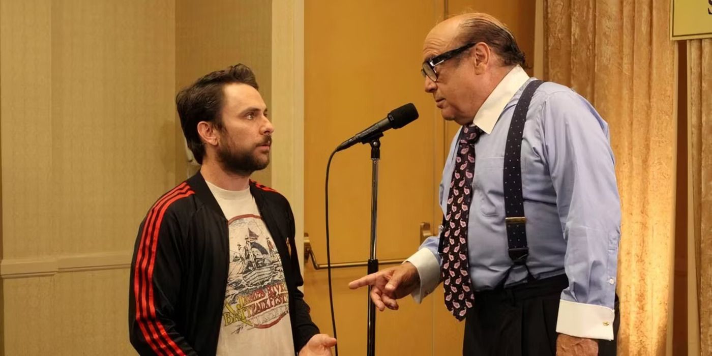 Frank in a suit with a microphone talking to Charlie in &lsquo;It&rsquo;s Always Sunny in Philadelphia&rsquo;.