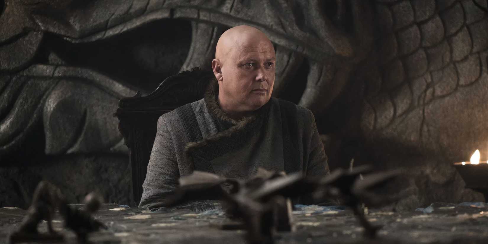Conleth Hill as Varys sitting in at a war map in Game of Thrones