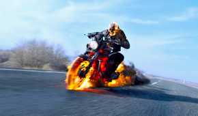 Ghost Rider (played by Nicolas Cage), rides his flaming motorbike down a freeway in Spirit of Vengeance.