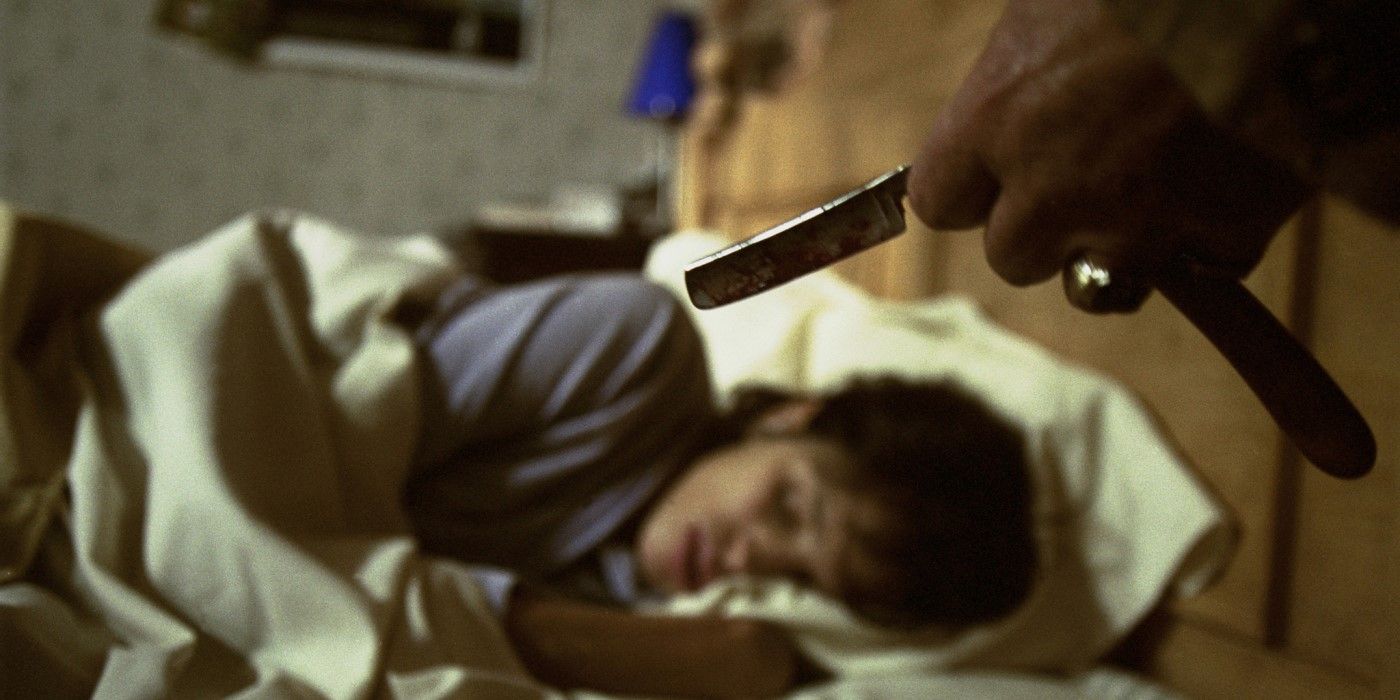 Someone holds a bloody razor while watching a woman sleep in 'High Tension'