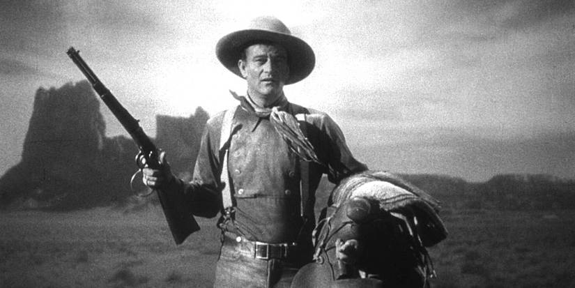 John Wayne as The Ringo Kid standing in an open field in Stagecoach.
