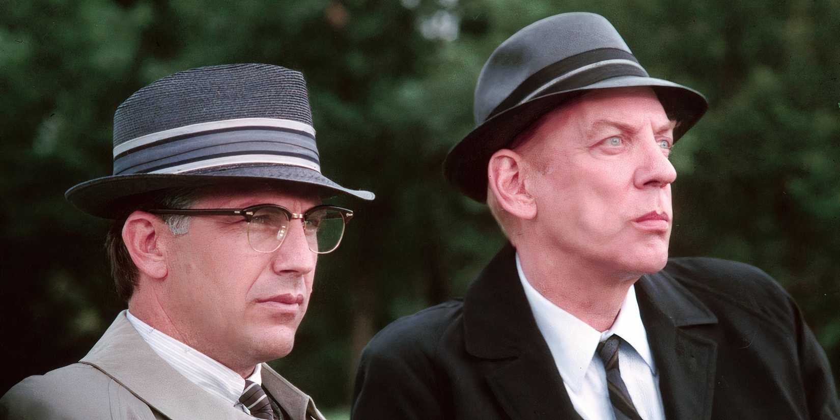 Kevin Costner and Donald Sutherland sit on a park bench in Oliver Stone's 'JFK'