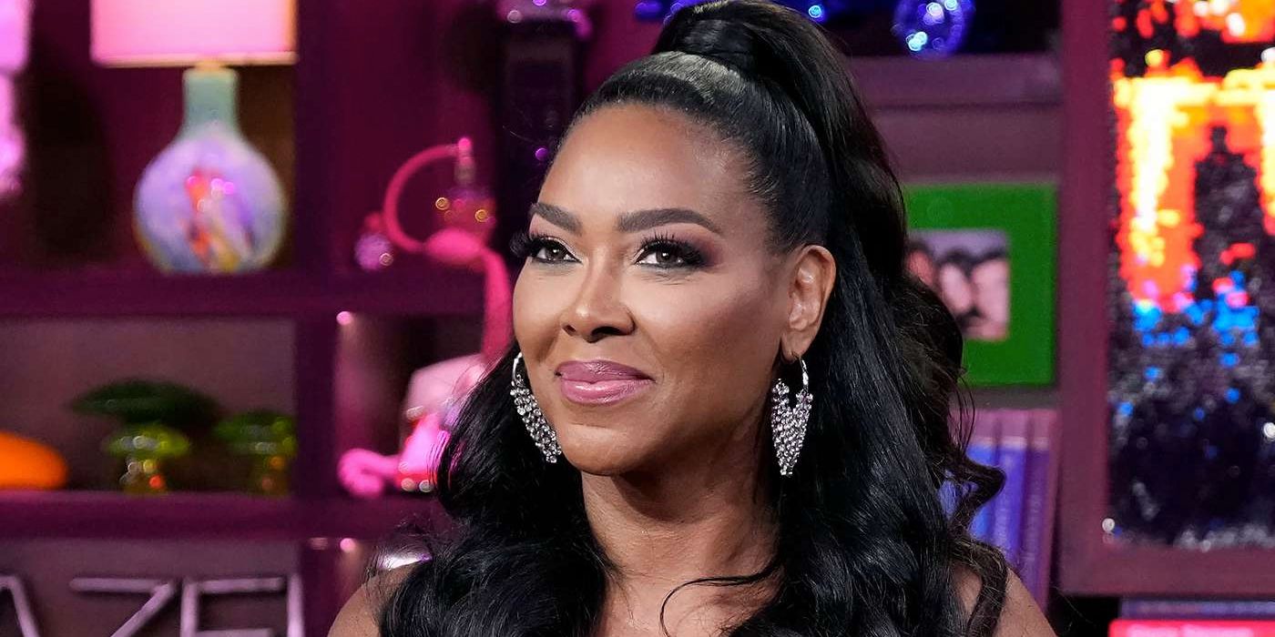 Kenya Moore has her hair tied up and back in a still from Andy Cohen Live.