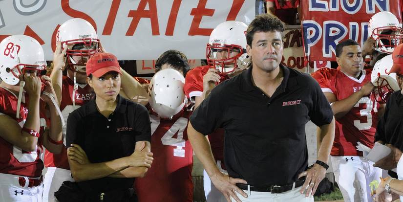 Jess (Jurnee Smollett) stands along Coach Taylor (Kyle Chandler) on the sidelines in Friday Night Lights.
