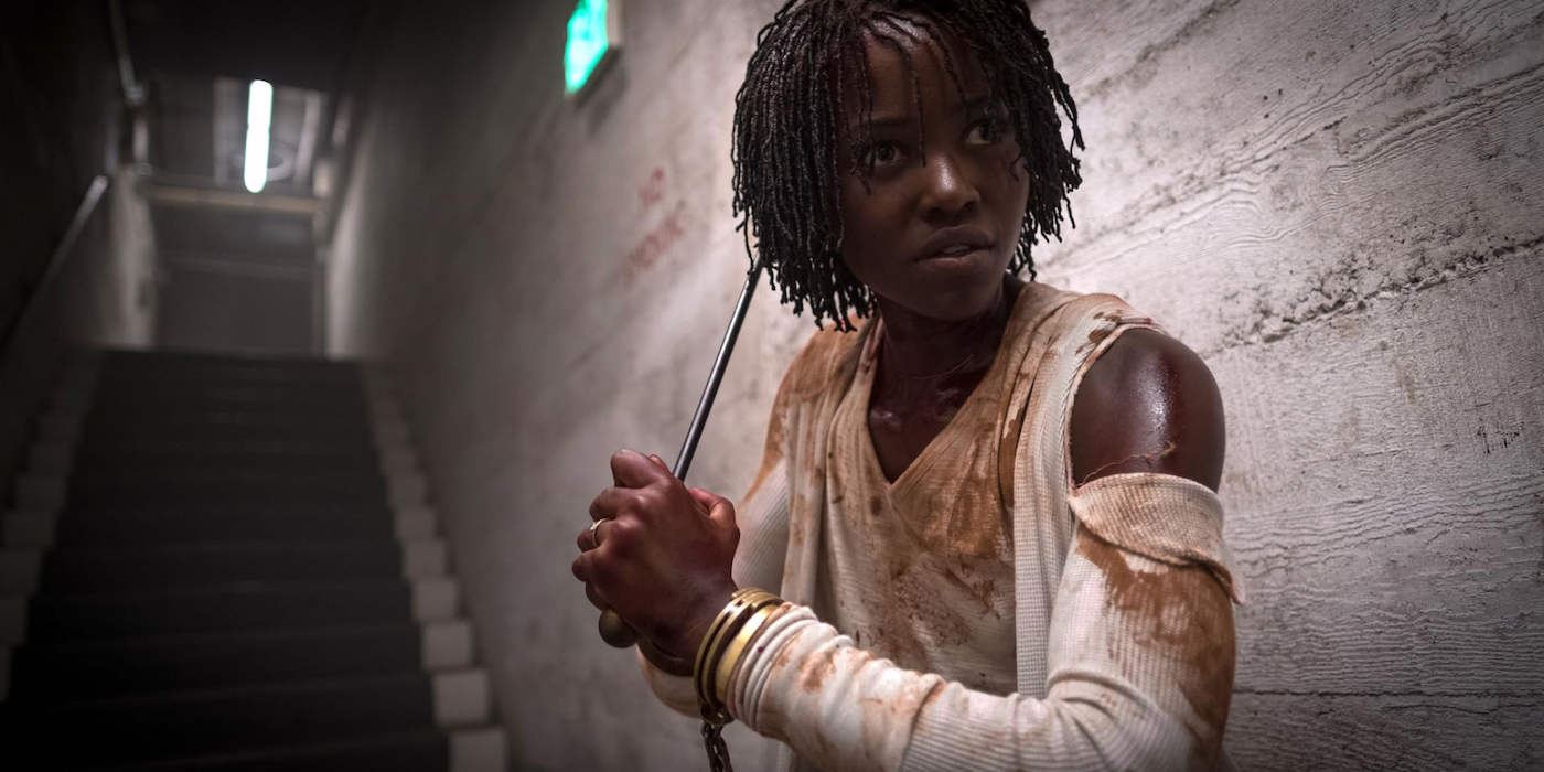 Lupita-Nyongo holding a metal bar in Us