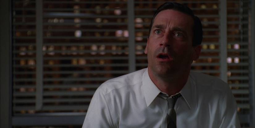 Sitting in a white shirt and tie in his office, Don Draper (Jon Hamm) looks aggrevated and bemused as he argues with an employee in 'Mad Men' Season 4, Episode 7 "The Suitcase" (2011).