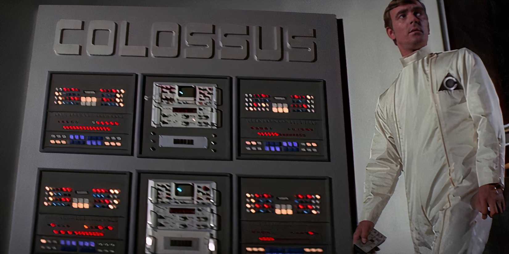 A man next to a machine with the name COLOSSUS at the top in Man in Colossus- The Forbin Project (1970)