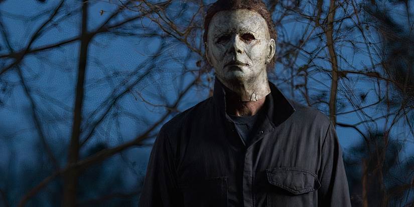 Michael Myers (James Jude Courtney) standing in a forest in 'Halloween' (2018).