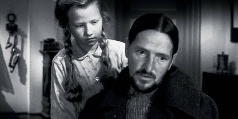 A young girl approaching a man from behind in Ordet