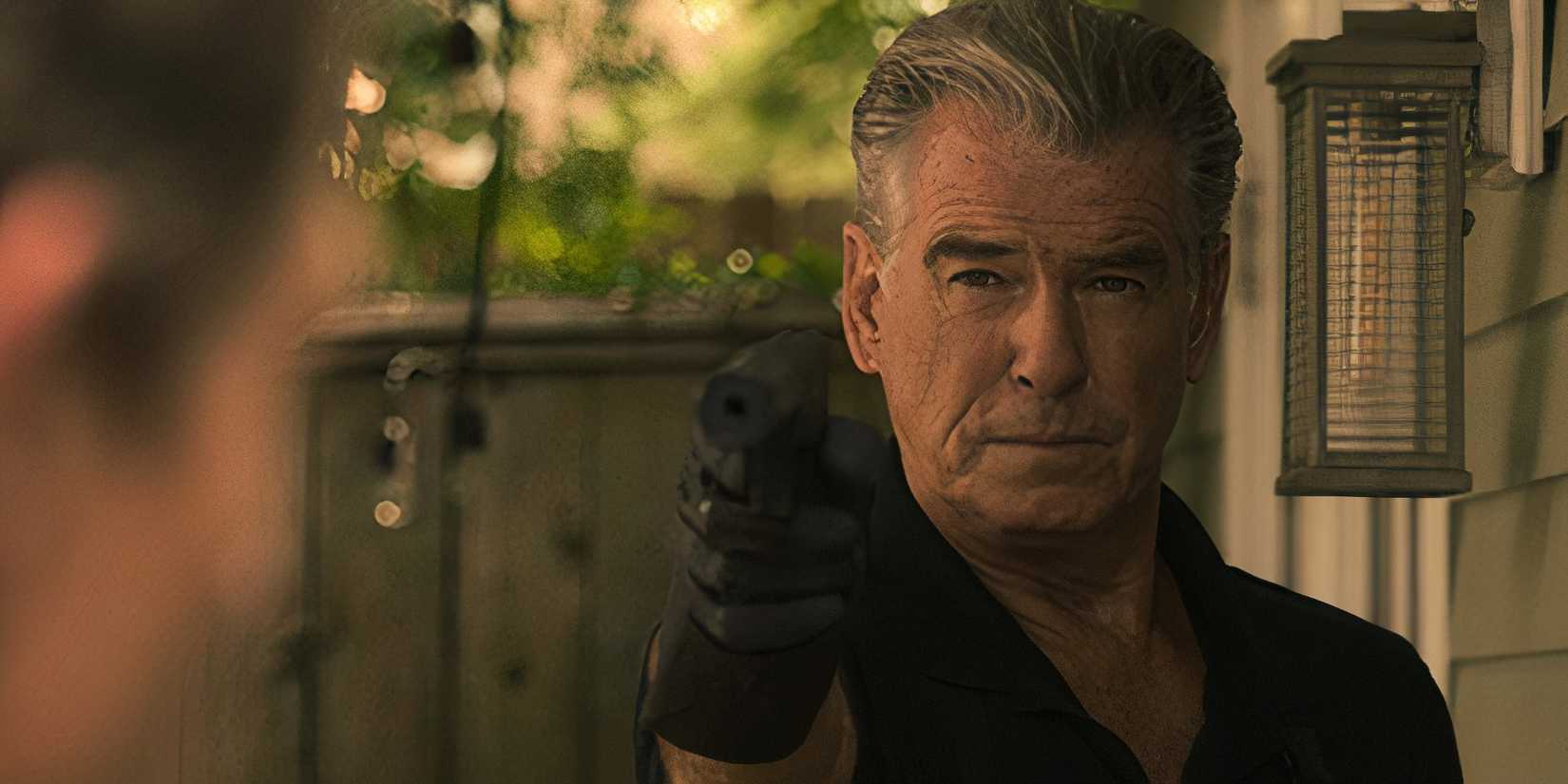 Pierce Brosnan holding a gun in Fast Charlie