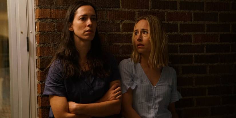 Beth Parchin (Rebecca Hall) and Claire (Sarah Goldberg) stand outside at night in 'The Night House'