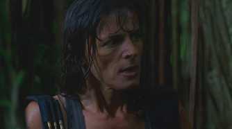 Danielle Rousseau (played by Mira Furlan), soaked from the rain, advises the survivors on how to avoid the Monster in Lost’s Season 1 Episode ‘Exodus.’