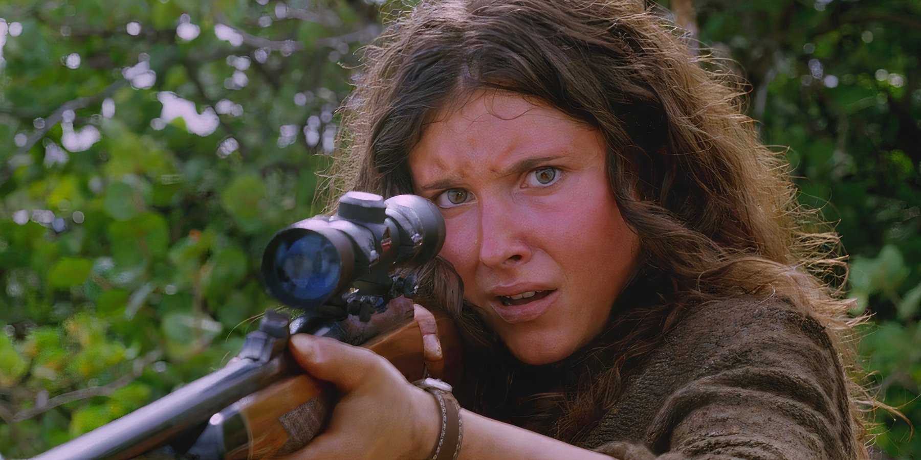 A young Danielle Rousseau (played by Melissa Farman), lifts a hunting rifle, protecting herself from her infected crew in Lost’s Season 5 Episode This Place is Death.