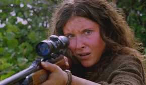 A young Danielle Rousseau (played by Melissa Farman), lifts a hunting rifle, protecting herself from her infected crew in Lost’s Season 5 Episode This Place is Death.