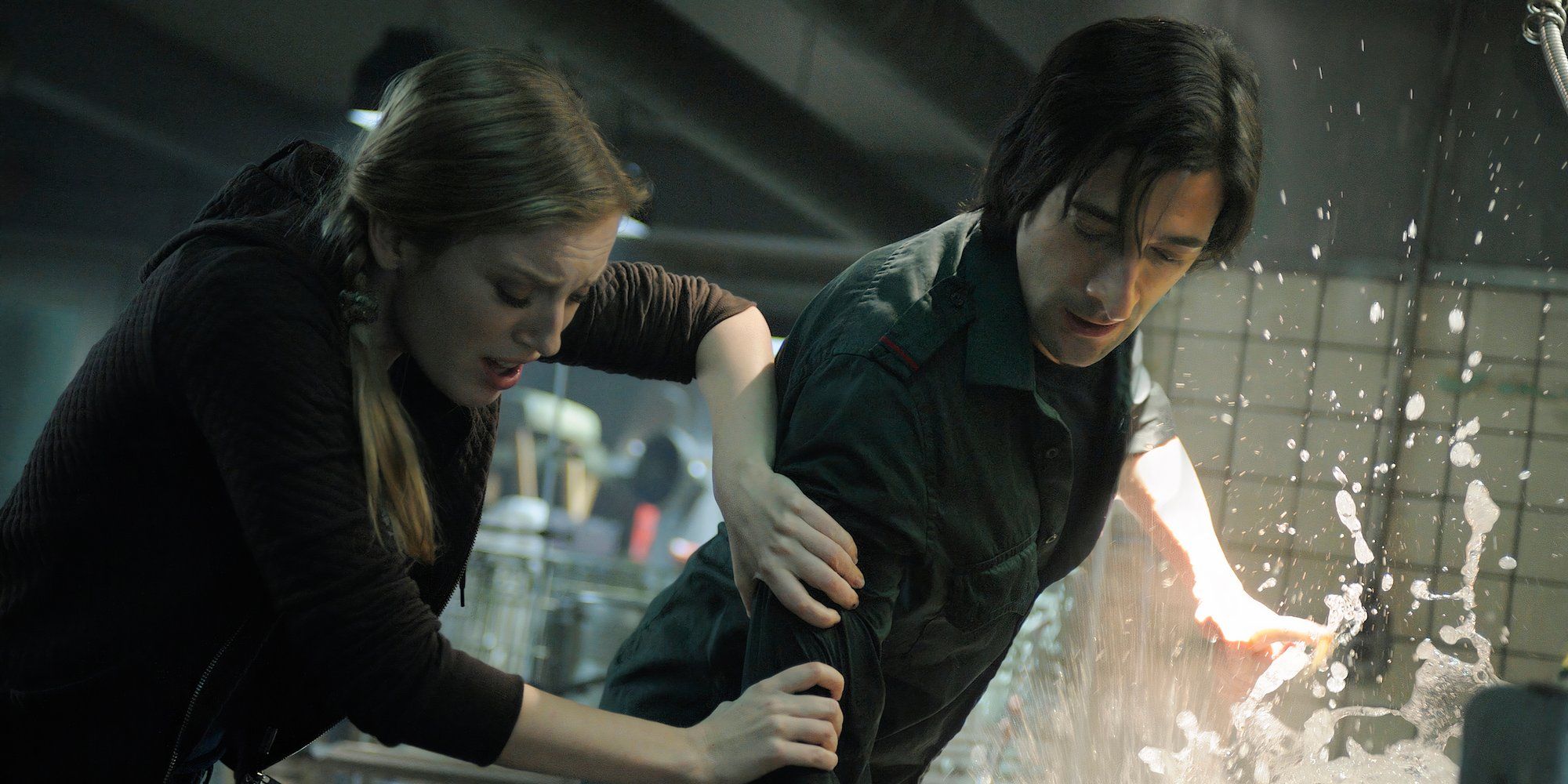 Sarah Polley and Adrien Brody worried at something splashing in a bathtub in Splice