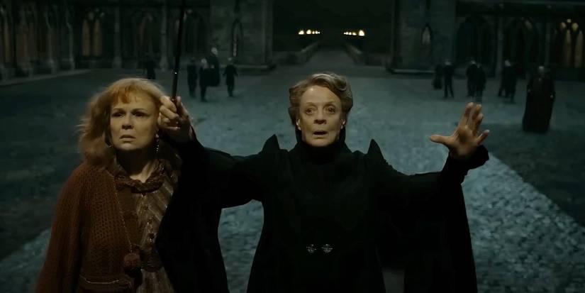 Minerva McGonagall, arms raised, protecting Hogwarts beside Molly Weasley in Deathly Hallows Part 2.