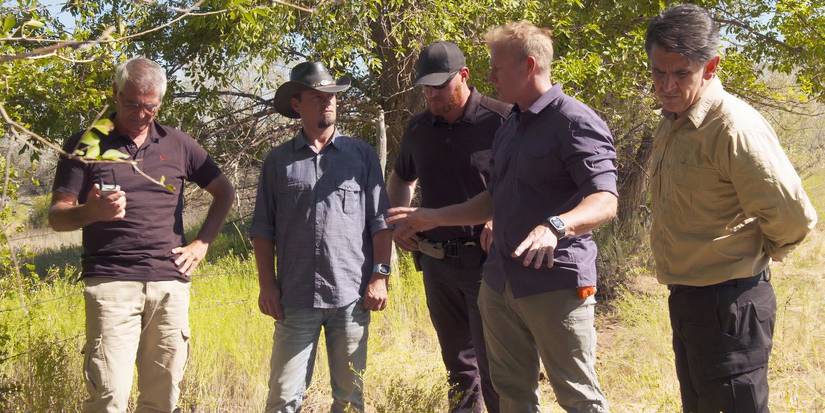 Five men standing on a ranch talking in The Secret of Skinwalker Ranch