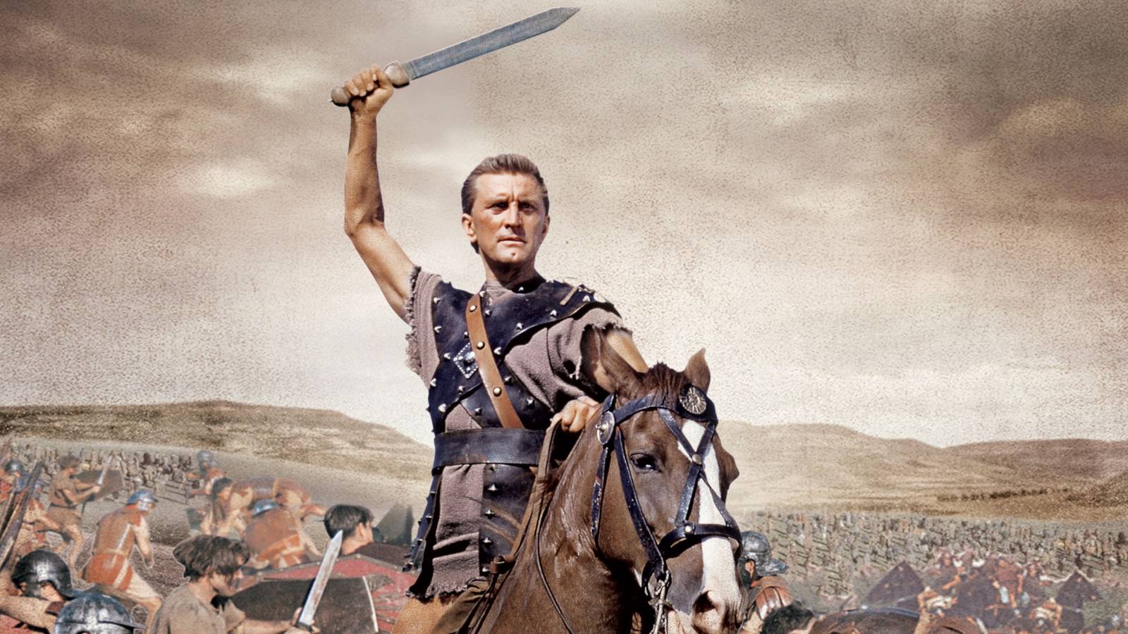 Kirk Douglas raising a sword while n horseback in Spartacus