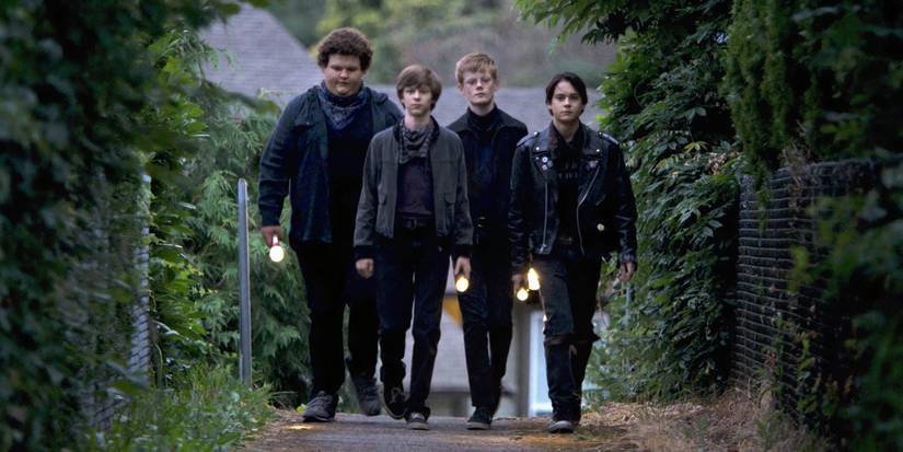 A group of young boys with flashlights in Summer of 84.