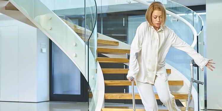 Tatiana Maslany as Rachel clone walking down staircase wearing white pajamas in the episode "The Antisocialism of Sex" in Orphan Black