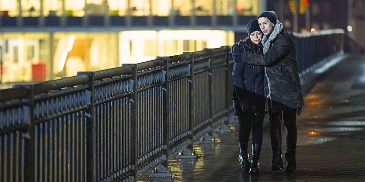 Tatiana Maslany as Sarah walking on the bridge at night wearing dark clothing with her brother Felix from the episode "The Antisocialism of Sex" in Orphan Black