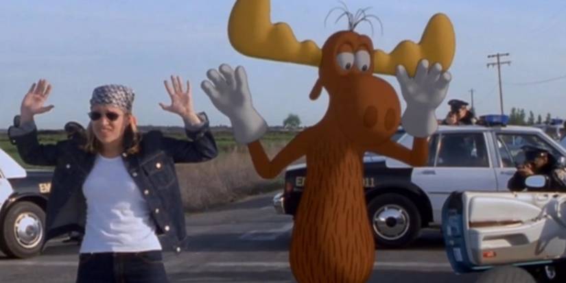Piper Perabo raising her hands next to Bullwinkle in 'The Adventures of Rocky and Bullwinkle' (2000)