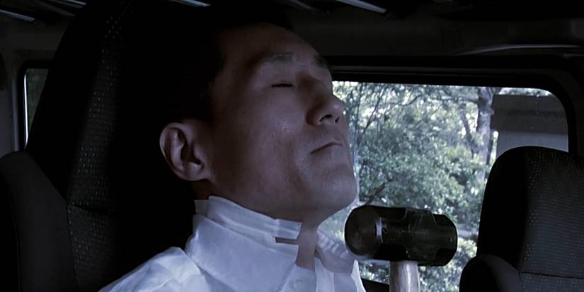 The Doctor holds a hammer as he waits in his van for his next victim in Grotesque