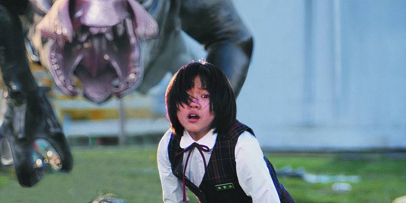 A young girl looking scared while a monster roars behind her in The Host (2006).