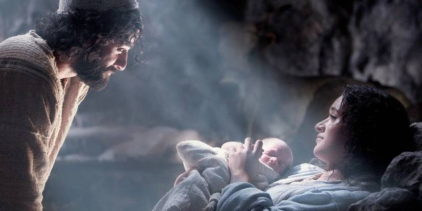 Mary and Joseph look at each other while Mary holds the newborn baby Jesus in The Nativity Story.