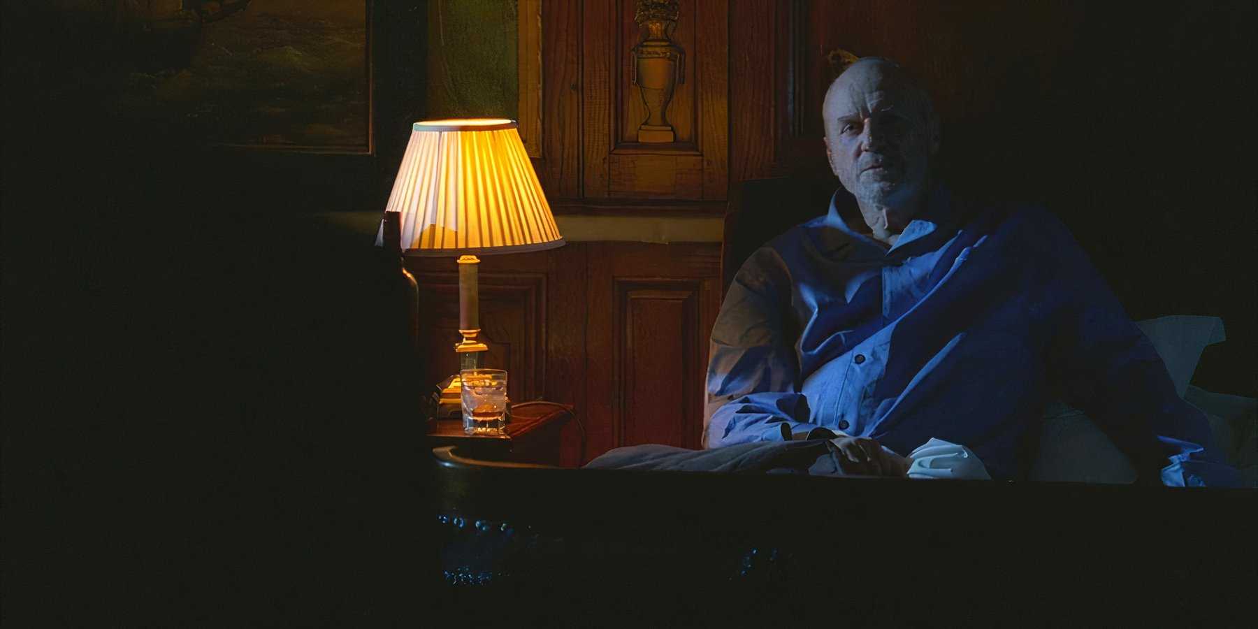 Charles Widmore (played by Alan Dale), sits up next to bed, where Benjamin Linus (Michael Emerson), has snuck in to threaten him in Lost’s Season 4 Episode ‘The Shape of Things to Come.’
