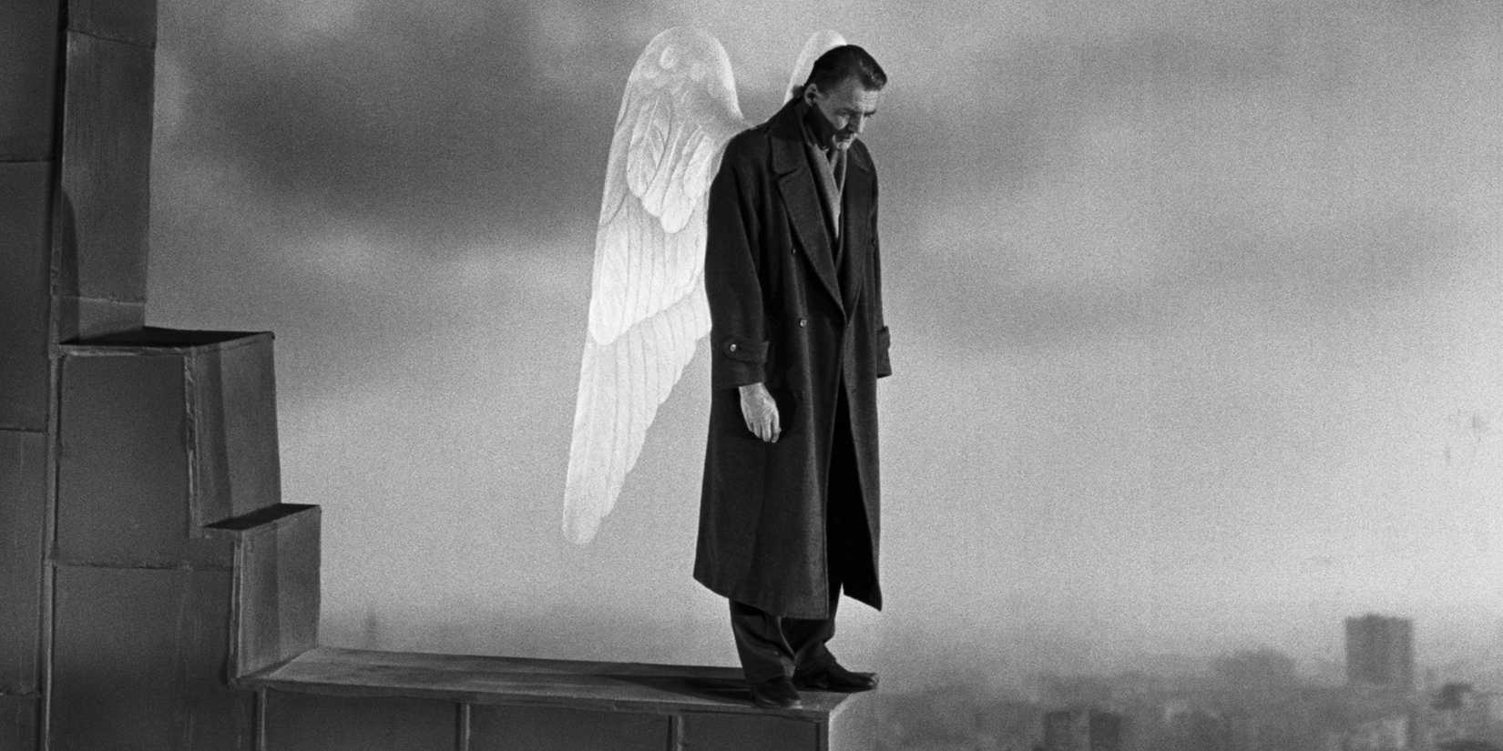 An angel atop a building looking down in Wings of Desire