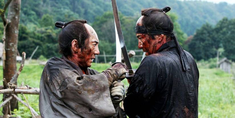 Two men engaged in a fight to the death, with swords, in 13 Assassins (2010)