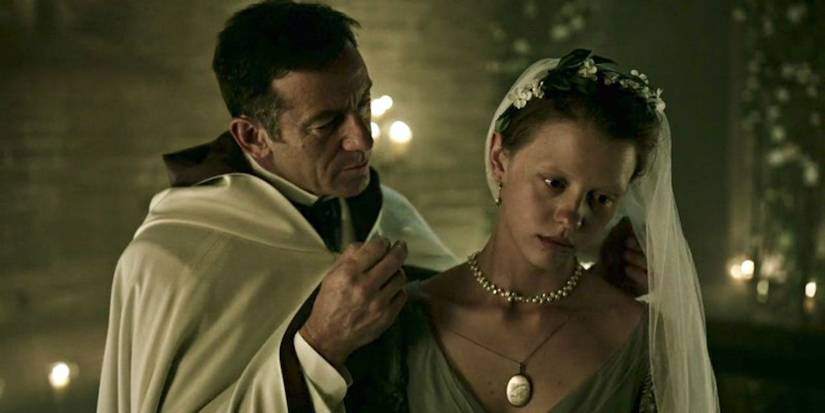 A priest putting a necklace on a despondent bride in A Cure for Wellness