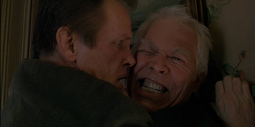 Nick Nolte and James Coburn share a nasty hug in Affliction, the neo noir crime thriller 