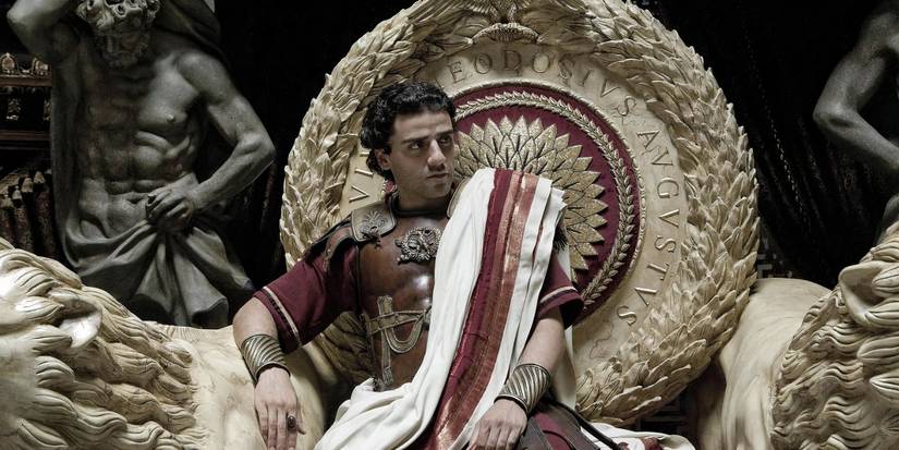 Oscar Isaac as a Roman ruler sitting on an elaborate throne in Agora.