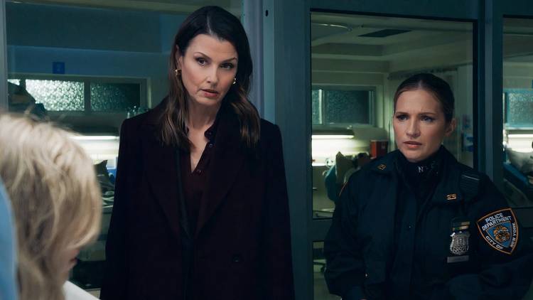 Erin Reagan and Edit Janko-Reagan talk to a victim who's in a hospital bed in "Dropping Bombs."