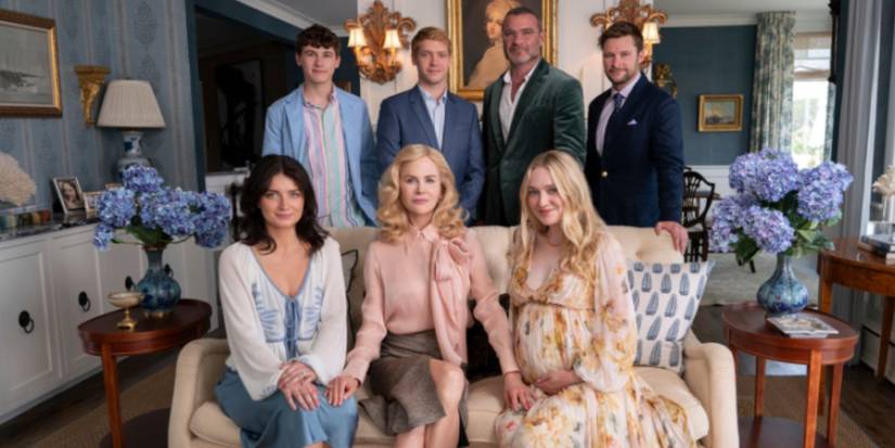 Nicole Kidman Dakota Fanning, Liev Schreiber, and more sitting on and standing next to the sofa for a family photo in 'A Perfect Couple'.